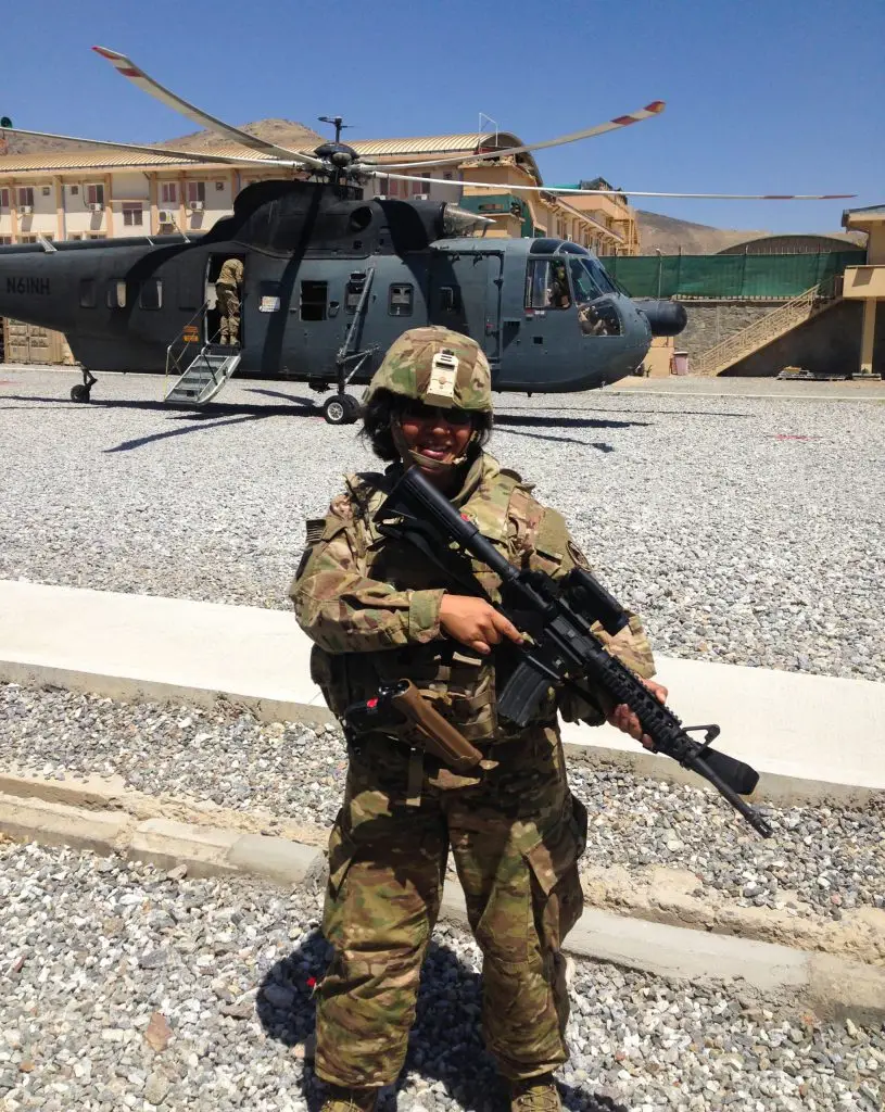 Photo of Jennifer Finch standing in front of a helicopter